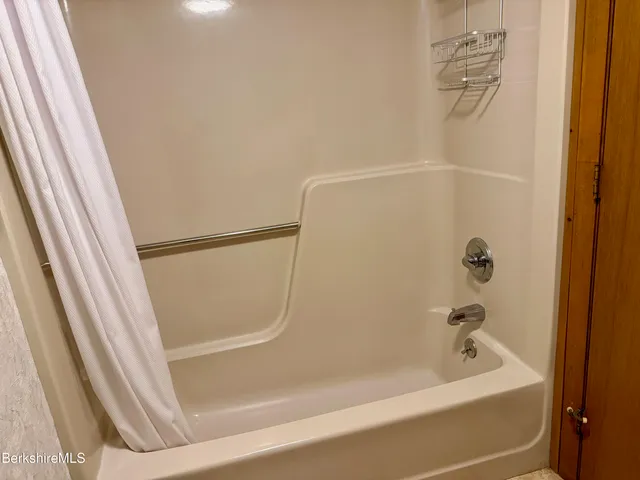 an empty room with wooden floor and a window