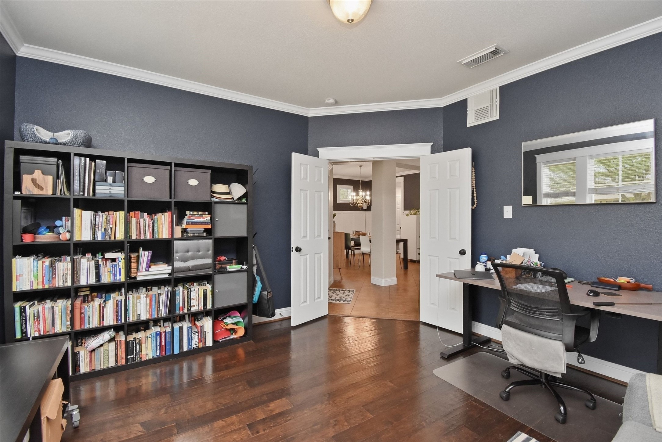 5615 Edgewood Pl Drive Spring, TX 77379 - Photo 11 of 48 Spacious home office with rich wood flooring, double doors and ample room for work or study, offering both functionality and privacy.