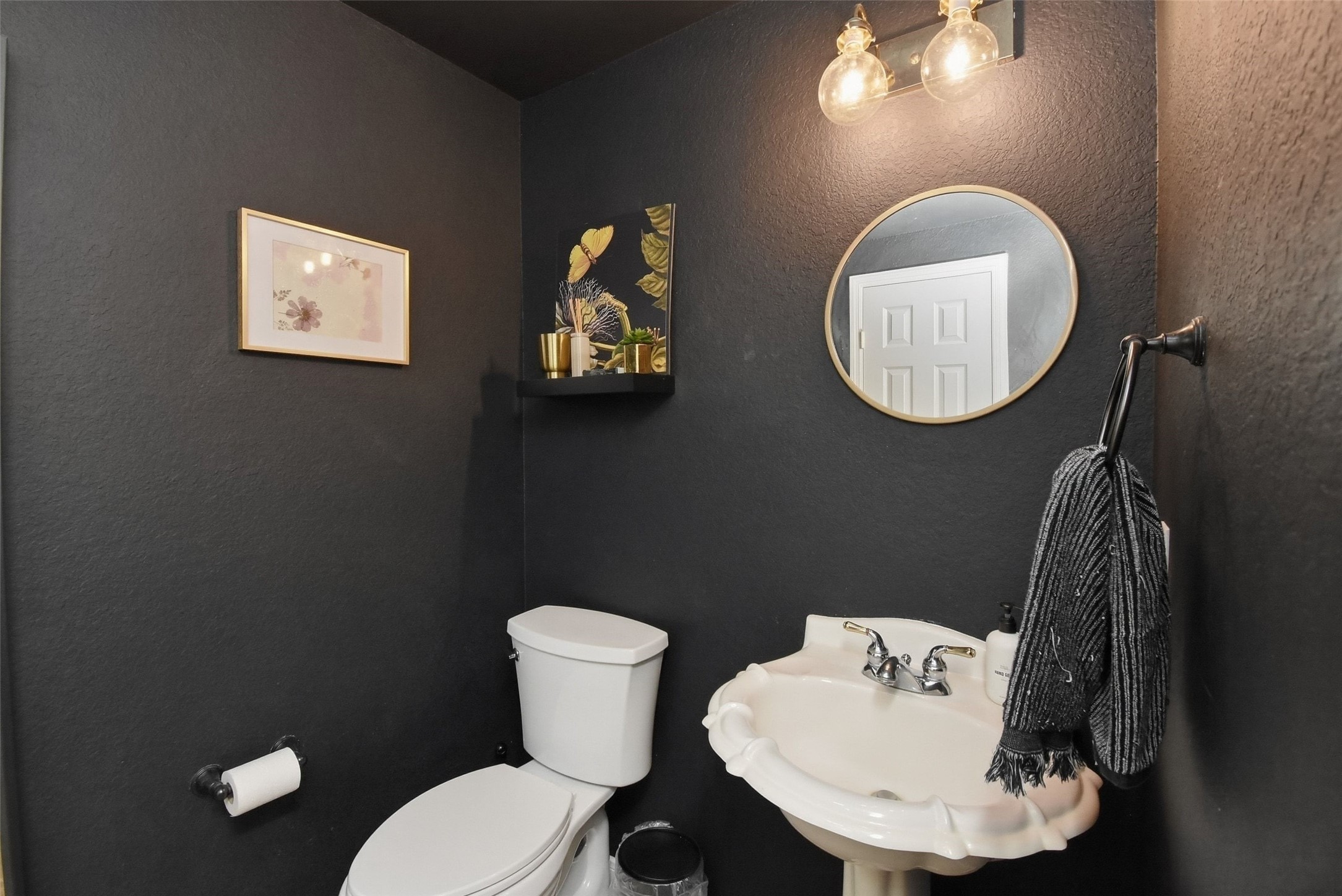 5615 Edgewood Pl Drive Spring, TX 77379 - Photo 14 of 48 Stylish half bath with bold accent walls, pedestal sink and modern lighting, adding character and convenience for guests.