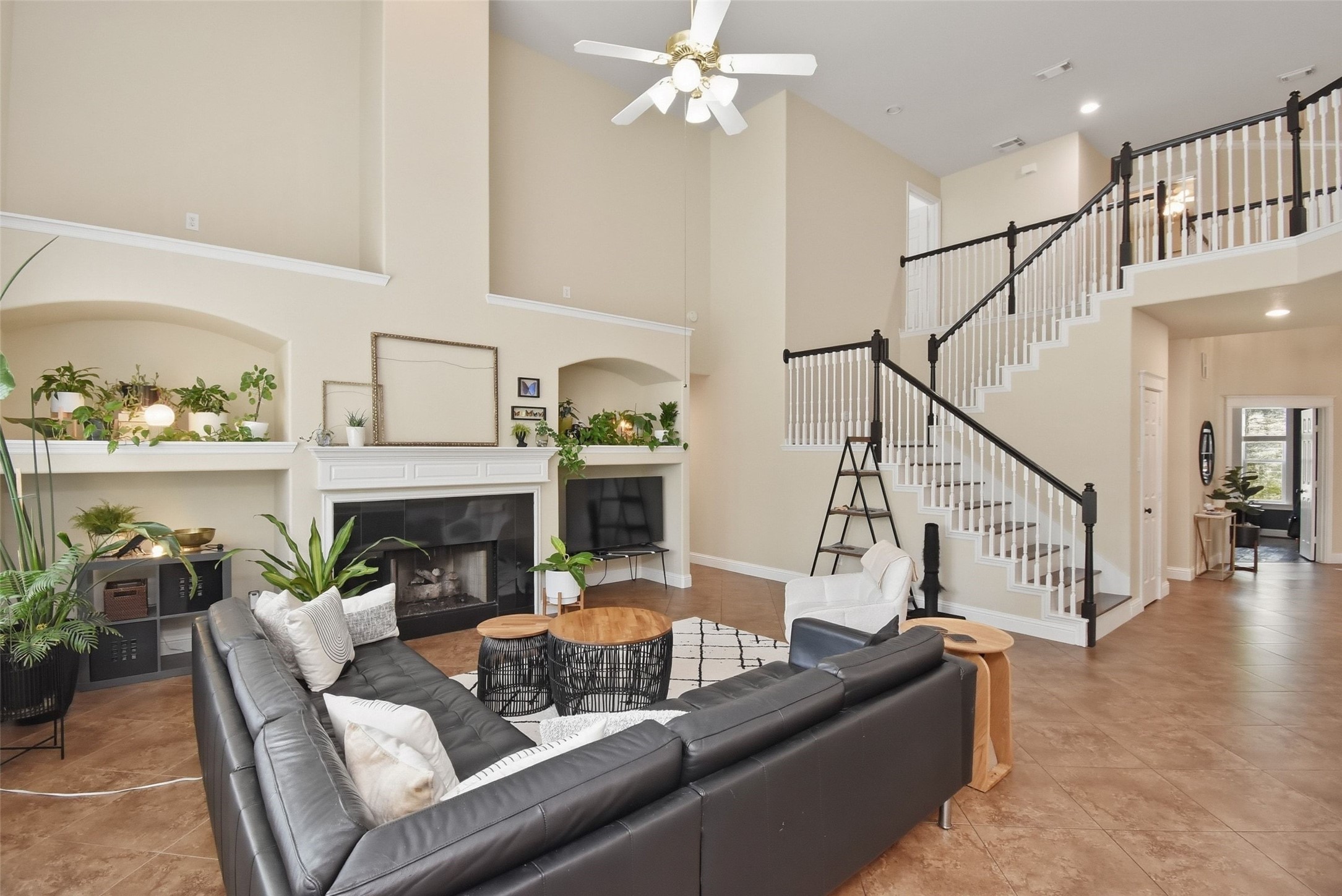 5615 Edgewood Pl Drive Spring, TX 77379 - Photo 16 of 48 Spacious living area with soaring ceilings, elegant fireplace and open staircase, creating a bright and inviting central gathering space.