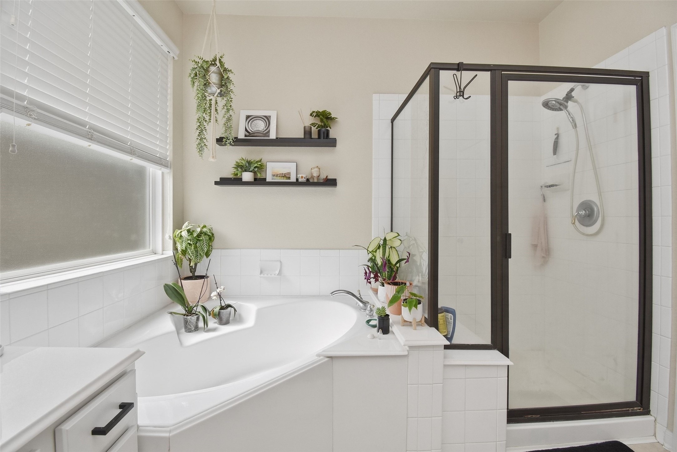 5615 Edgewood Pl Drive Spring, TX 77379 - Photo 32 of 48 Bright and inviting primary bath with a relaxing corner soaking tub, ideal for unwinding, and a spacious walk-in shower.