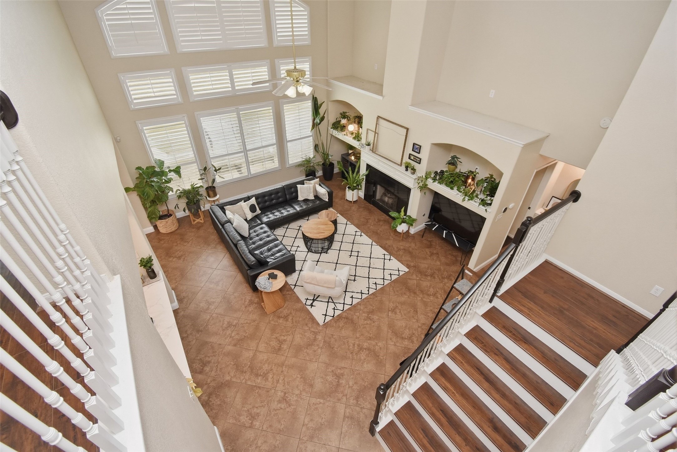 5615 Edgewood Pl Drive Spring, TX 77379 - Photo 33 of 48 Dramatic two-story living room viewed from the second floor, showcasing soaring ceilings, expansive windows and an open, airy feel.