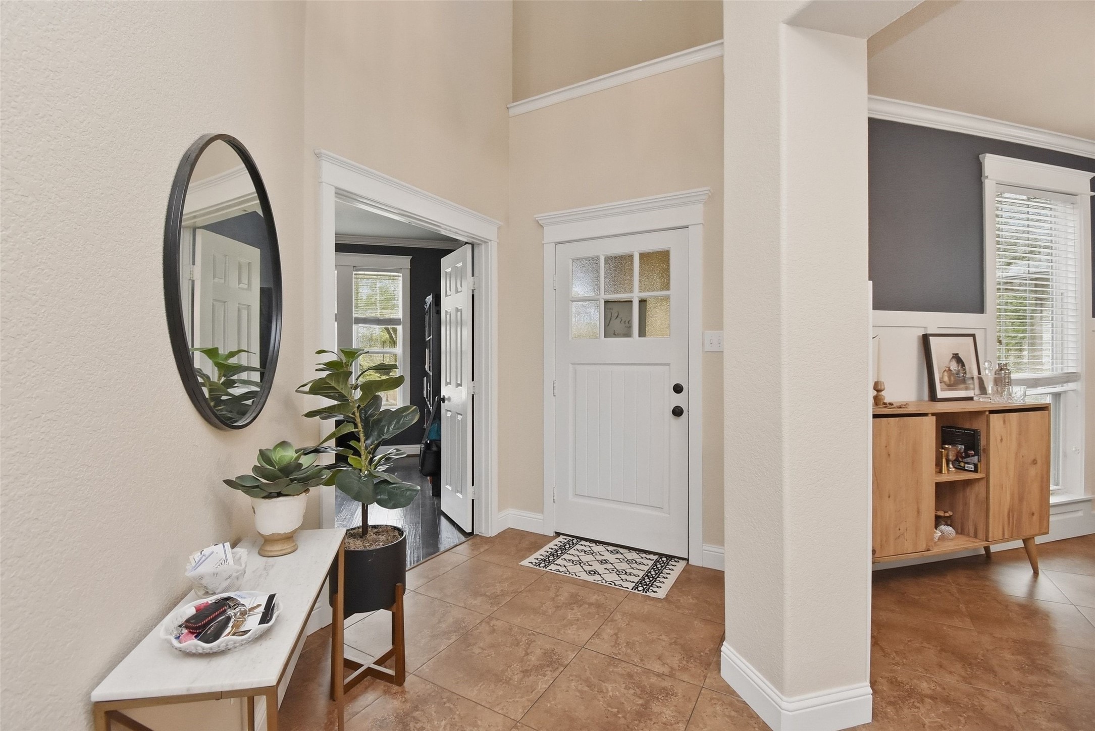 5615 Edgewood Pl Drive Spring, TX 77379 - Photo 6 of 48 Bright and welcoming entryway featuring soaring ceilings, tile flooring and a stylish console setup that creates a warm first impression.
