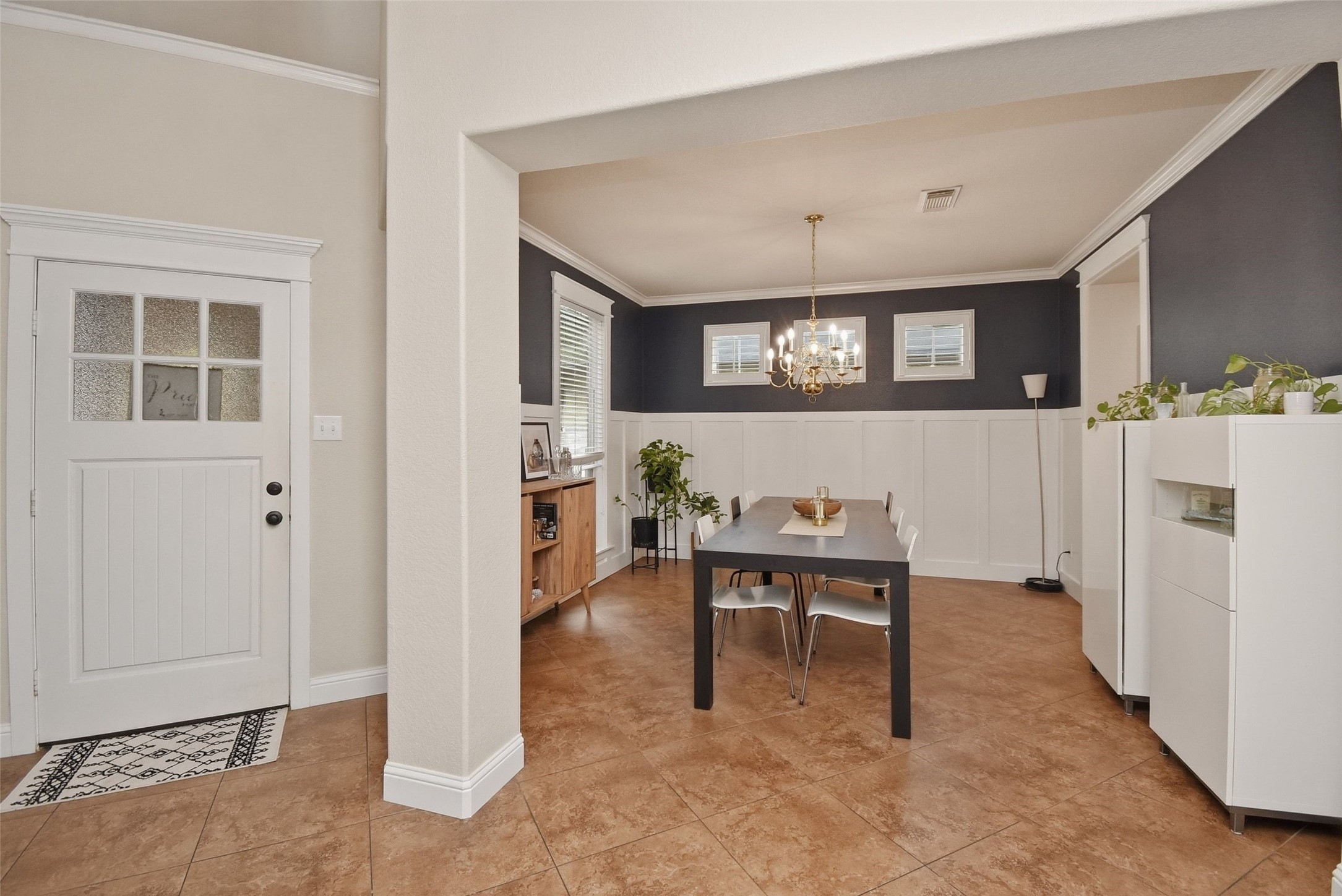 5615 Edgewood Pl Drive Spring, TX 77379 - Photo 7 of 48 Formal dining room with elegant wainscoting, crown molding and a statement chandelier, offering a perfect space for gatherings and entertaining.