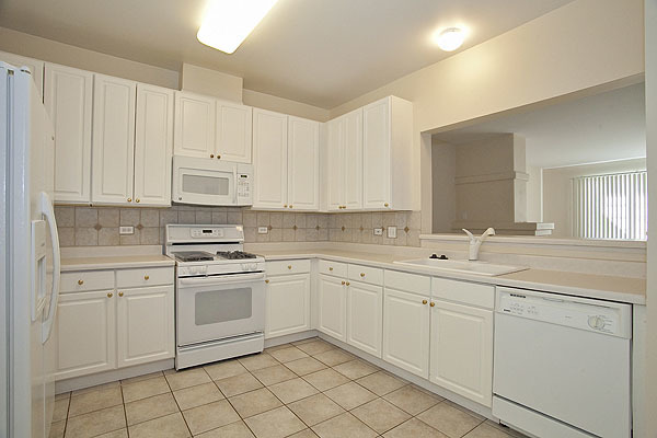 3448 Ravinia Circle Aurora, IL 60504 - Photo 6 of 20 a kitchen with white cabinets appliances and sink
