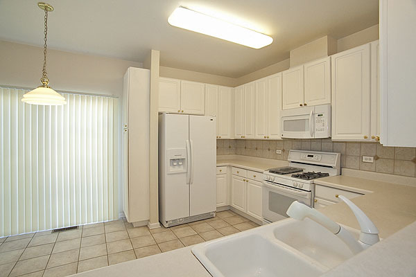 3448 Ravinia Circle Aurora, IL 60504 - Photo 7 of 20 a kitchen with stainless steel appliances a refrigerator sink and cabinets