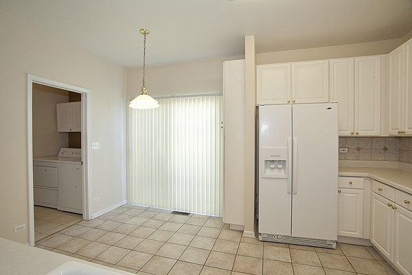 3448 Ravinia Circle Aurora, IL 60504 - Photo 8 of 20 a view of a kitchen with white cabinets and entryway