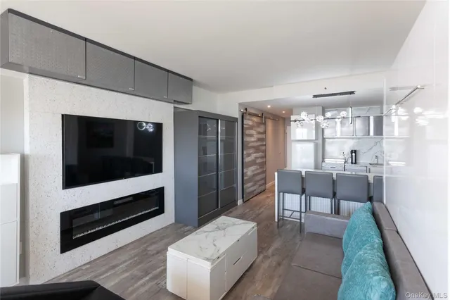 a view of a dining room with furniture a chandelier and wooden floor