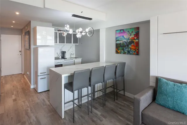 a kitchen with a refrigerator and white cabinets