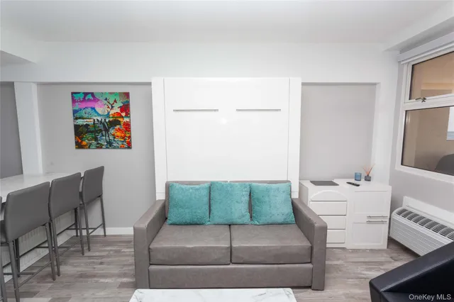 a living room with furniture and a floor to ceiling window