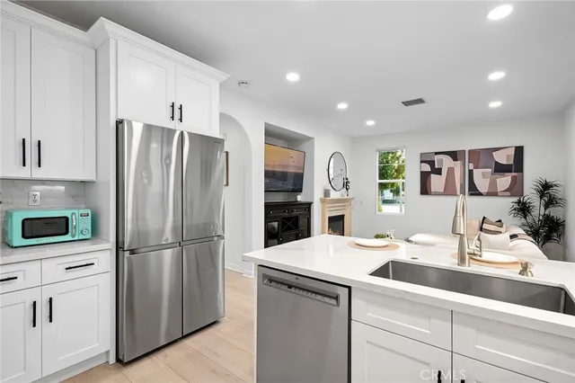 a living room with furniture a window and a potted plant