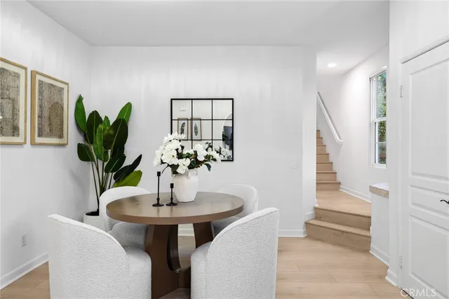 a living room with furniture a table and a potted plant