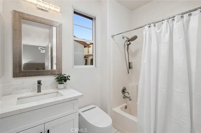 an aerial view of multiple houses with a yard