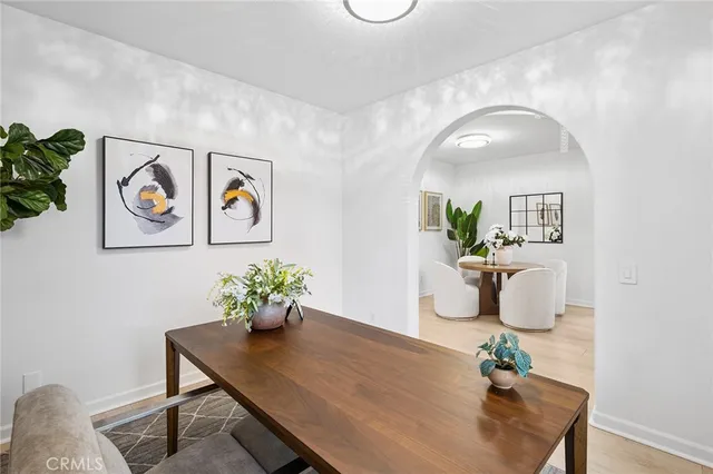 a dining room with furniture and wooden floor