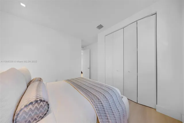 a bedroom with a bed and a closet