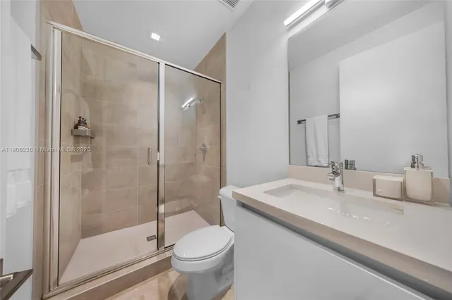 a bathroom with a sink toilet and shower