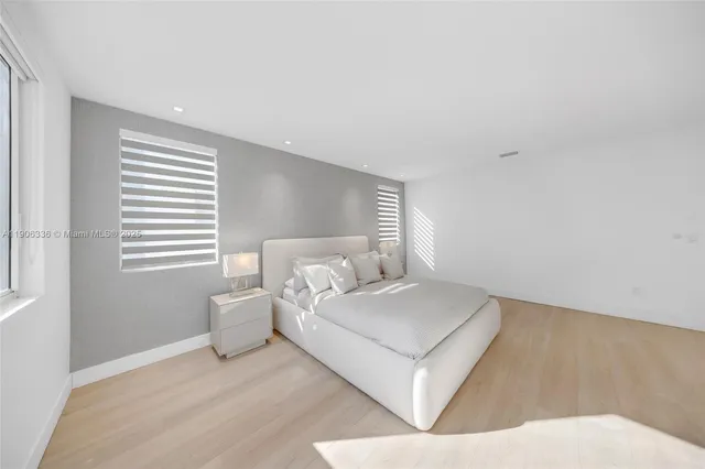 a room with a bed and a night stand