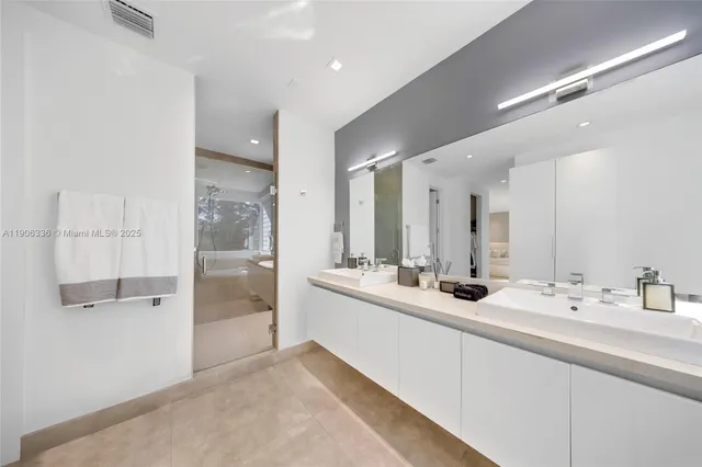 a bathroom with a double vanity sink and mirror