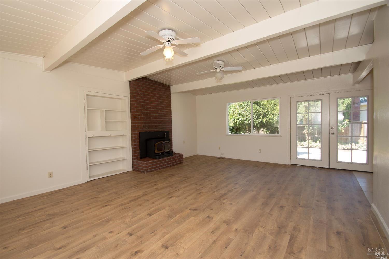 701 Corlano Avenue Santa Rosa, CA 95404 - Photo 9 of 22 Bookshelf to left of fireplace opens to Laundry Area and 2 car Garage