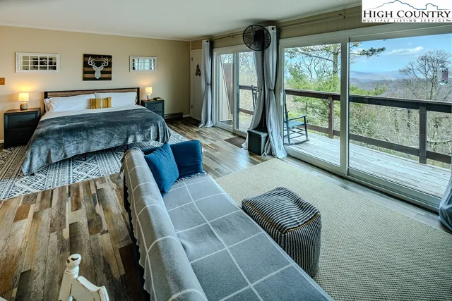 a living room with furniture and a floor to ceiling window