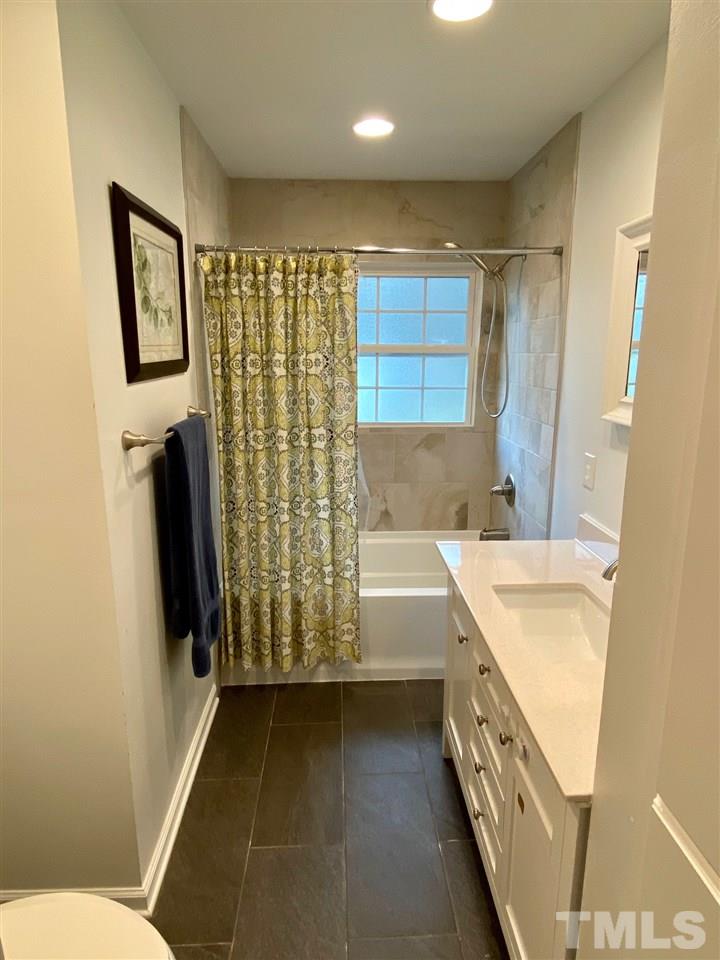 3701 Lail Court Raleigh, NC 27606 - Photo 12 of 25 a bathroom with a sink a toilet and a bathtub