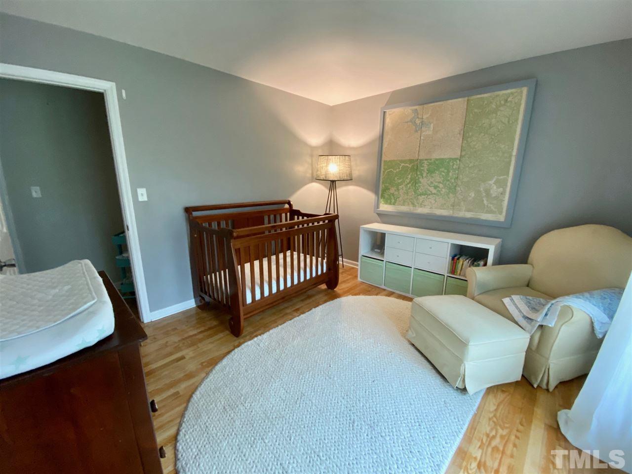 3701 Lail Court Raleigh, NC 27606 - Photo 13 of 25 a bedroom with a bed window and a table