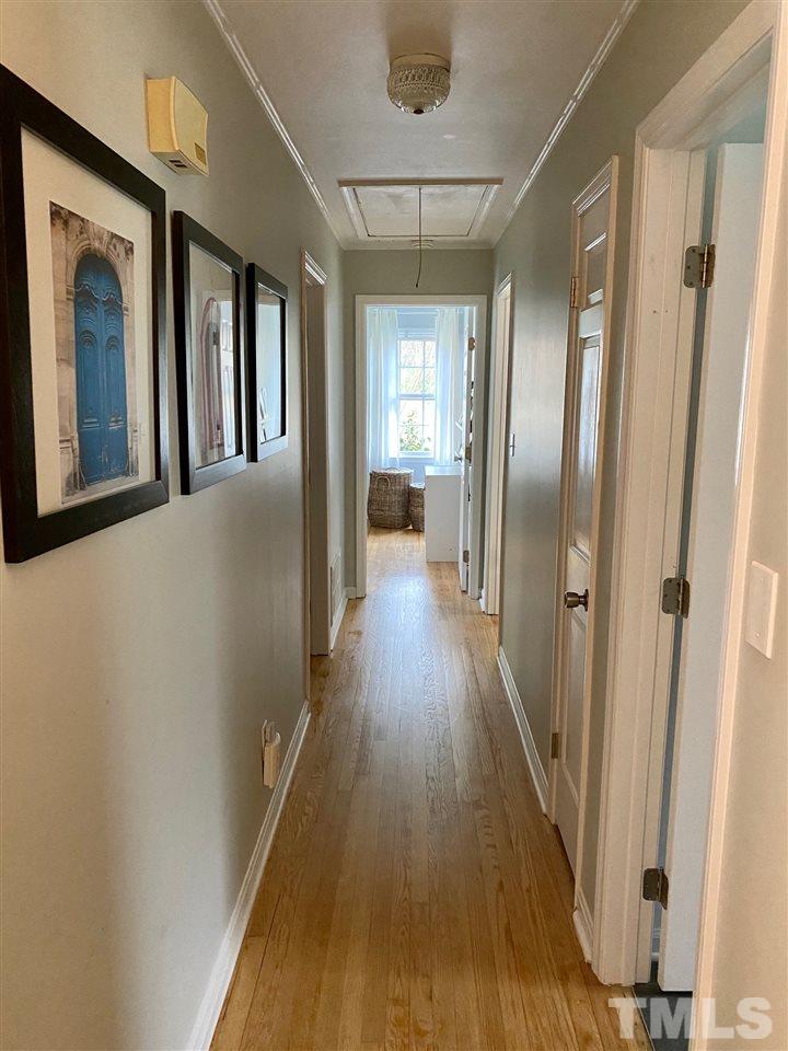 3701 Lail Court Raleigh, NC 27606 - Photo 16 of 25 a hallway with wooden floor chandelier and livingroom view