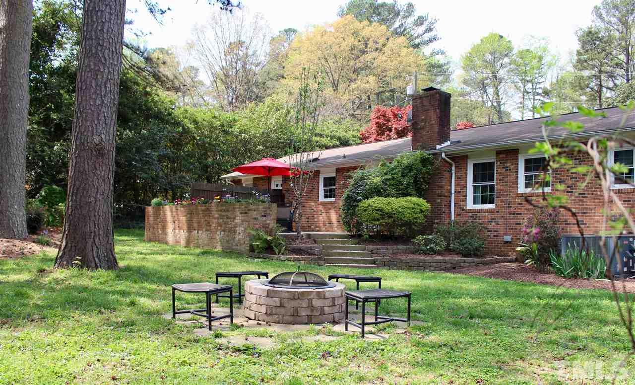 3701 Lail Court Raleigh, NC 27606 - Photo 20 of 25 a view of a house with backyard sitting area and garden