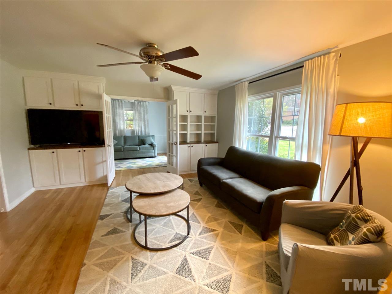 3701 Lail Court Raleigh, NC 27606 - Photo 3 of 25 a living room with furniture and a flat screen tv