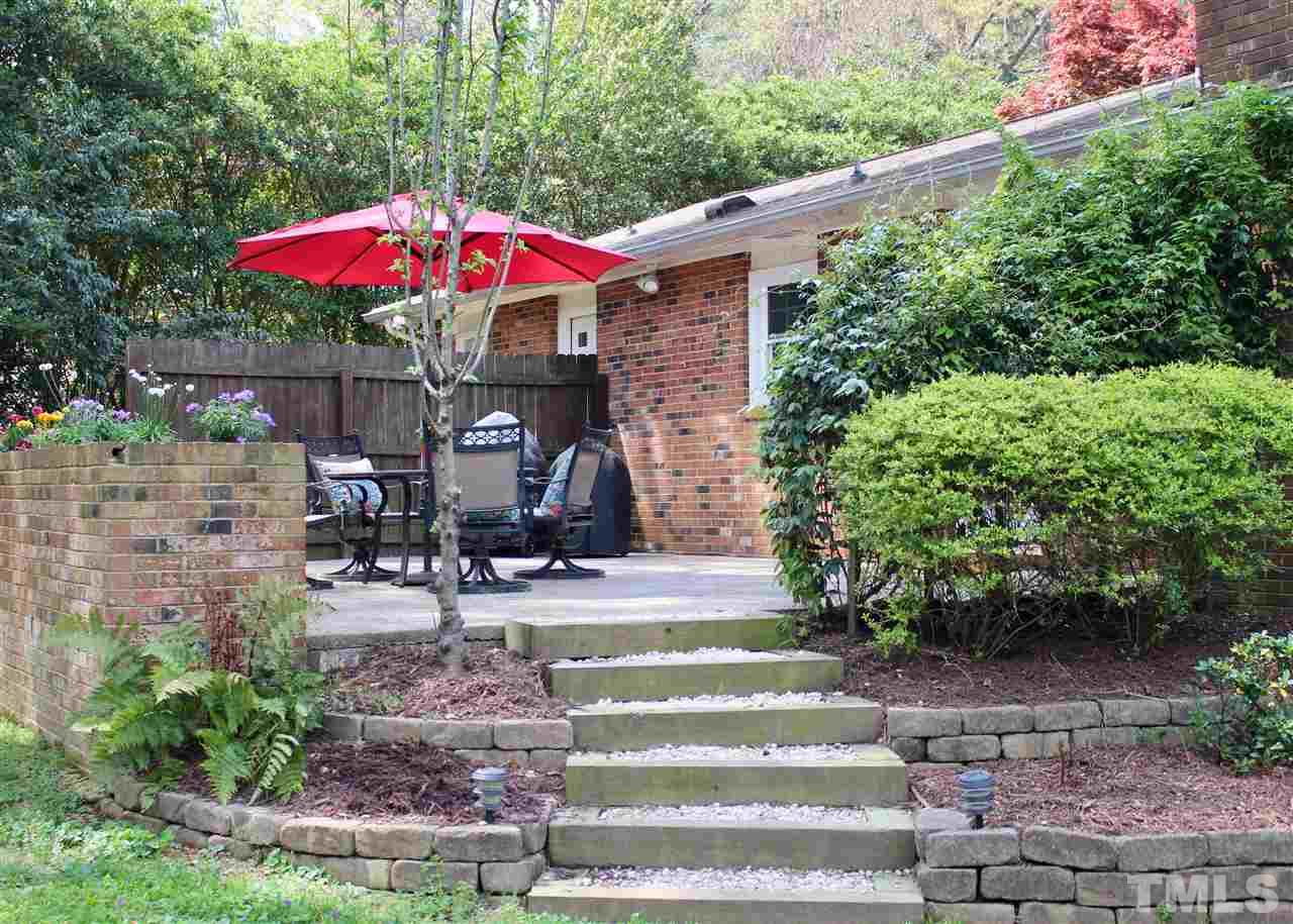 3701 Lail Court Raleigh, NC 27606 - Photo 21 of 25 a view of a patio with table and chairs under an umbrella