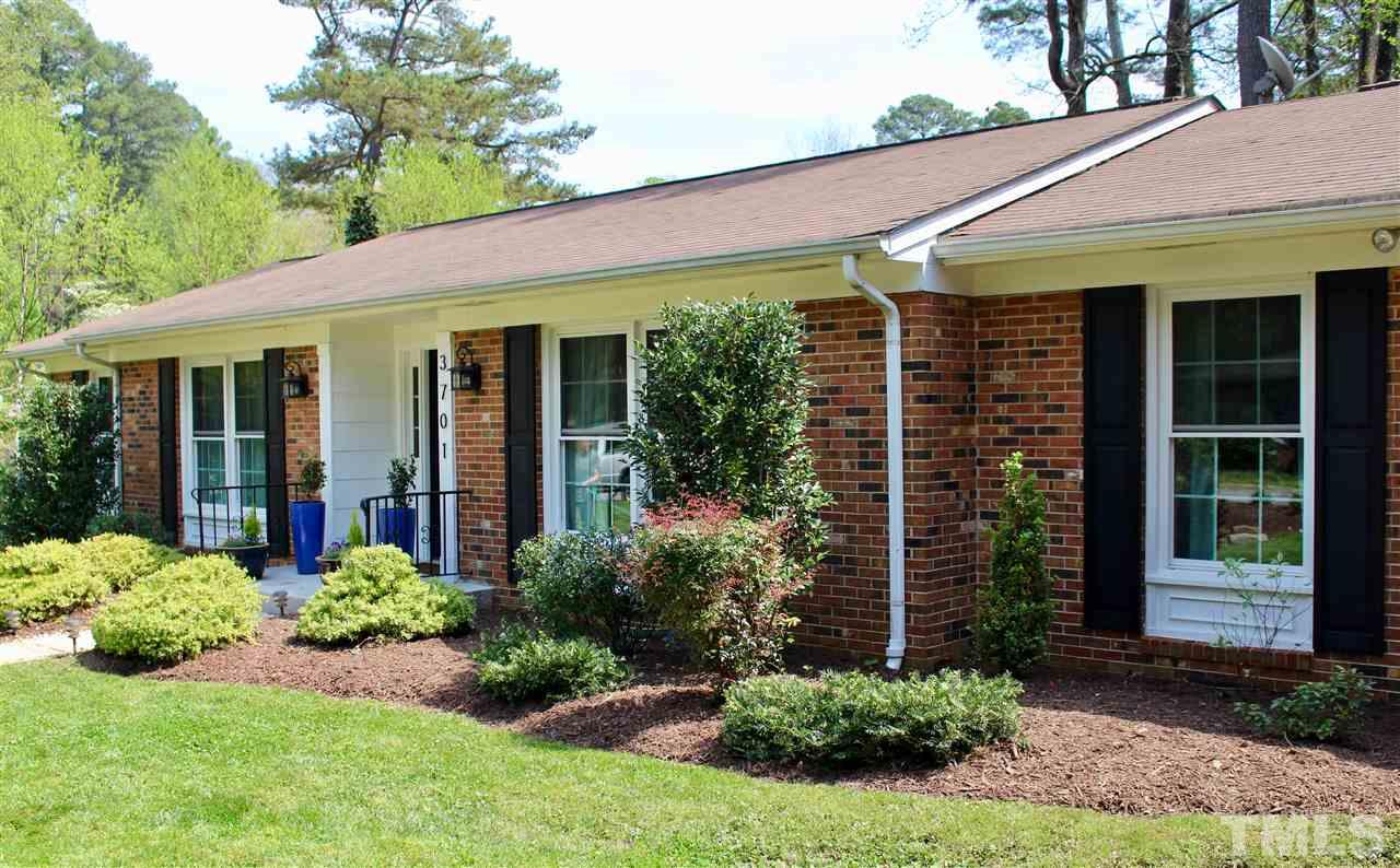 3701 Lail Court Raleigh, NC 27606 - Photo 24 of 25 a view of a house with potted plants and a table and chairs
