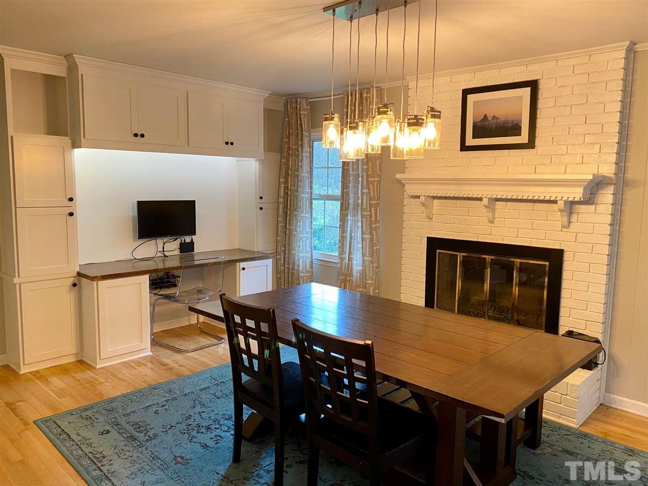 3701 Lail Court Raleigh, NC 27606 - Photo 4 of 25 a view of a dining room with furniture and a fireplace