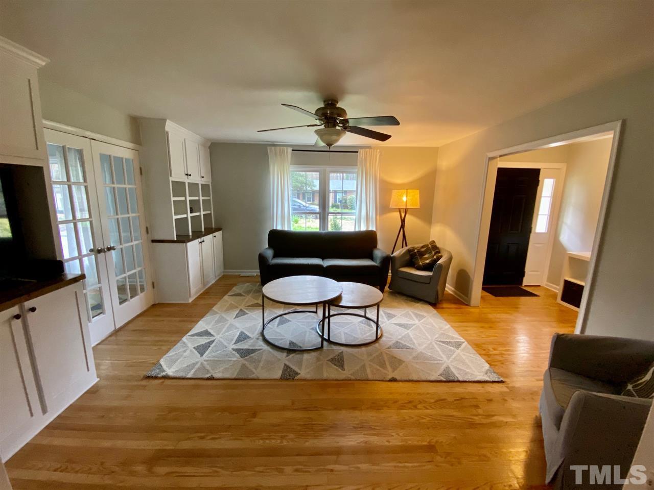 3701 Lail Court Raleigh, NC 27606 - Photo 5 of 25 a living room with furniture a window and a flat screen tv