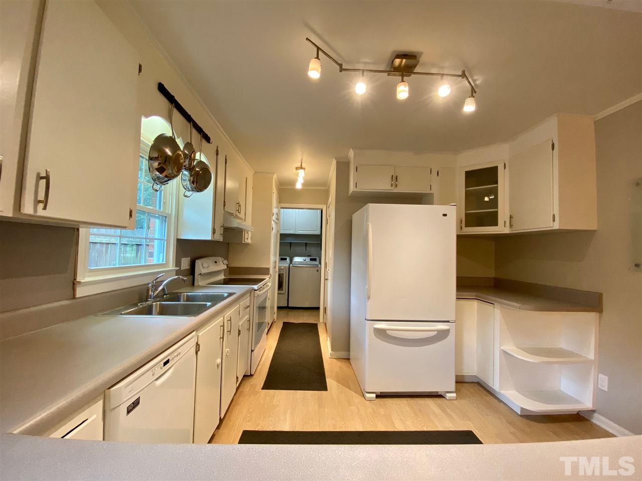 3701 Lail Court Raleigh, NC 27606 - Photo 7 of 25 a kitchen with a sink a refrigerator and cabinets