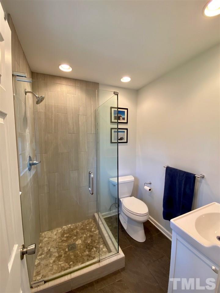 3701 Lail Court Raleigh, NC 27606 - Photo 9 of 25 a bathroom with a toilet a sink and a shower