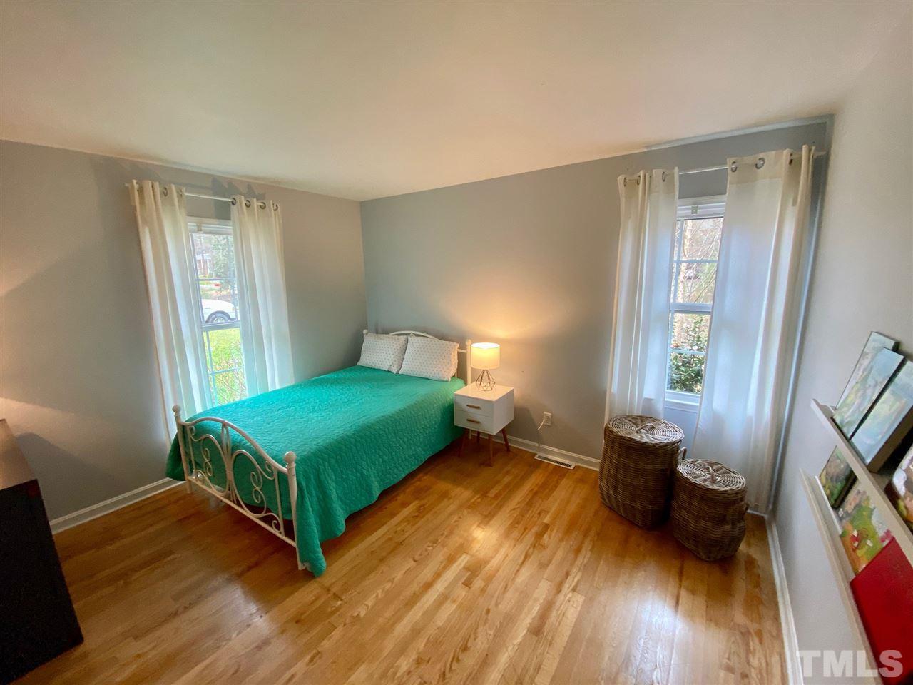 3701 Lail Court Raleigh, NC 27606 - Photo 10 of 25 a bedroom with a bed and a wooden floor
