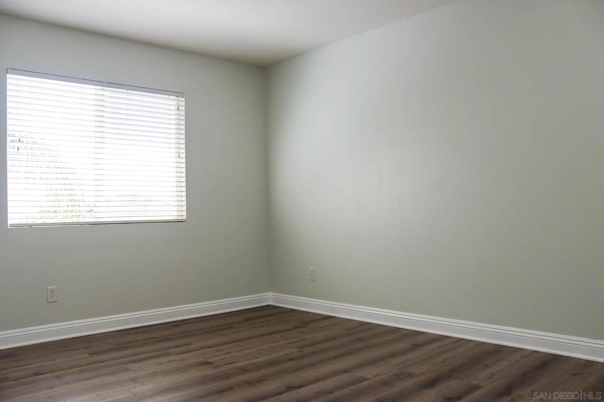 25301 Ridgemoor Road Menifee, CA 92586 - Photo 61 of 70 an empty room with wooden floor and a window