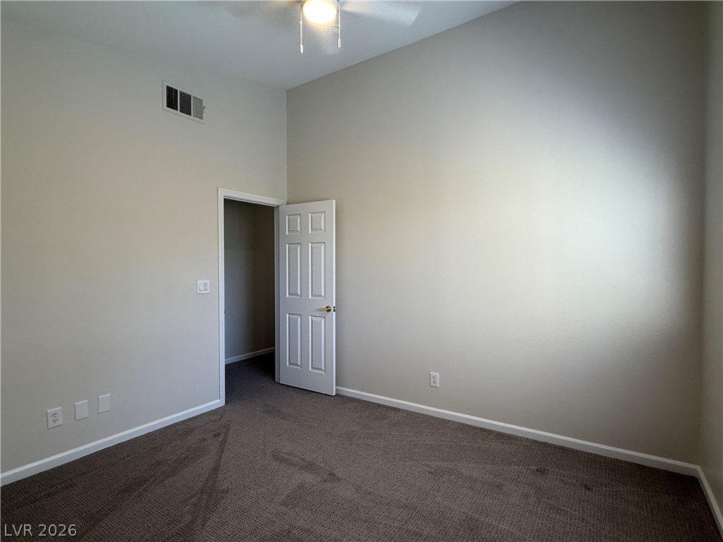 1908 Thunder Ridge Circle Henderson, NV 89012 - Photo 19 of 28 Comfortable carpet and a ceiling fan create a relaxing atmosphere in this versatile room.