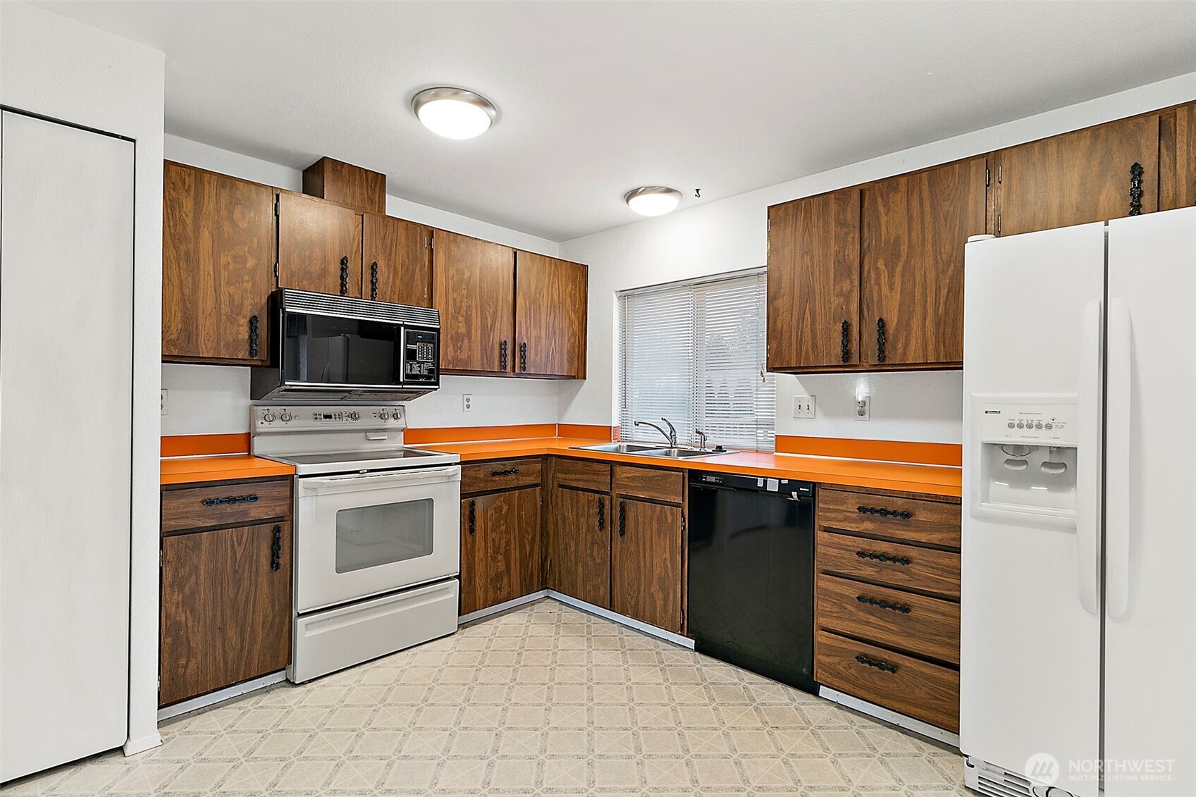 2115 Whitman Avenue Northeast Renton, WA 98059 - Photo 13 of 40 a kitchen with cabinets stainless steel appliances and sink