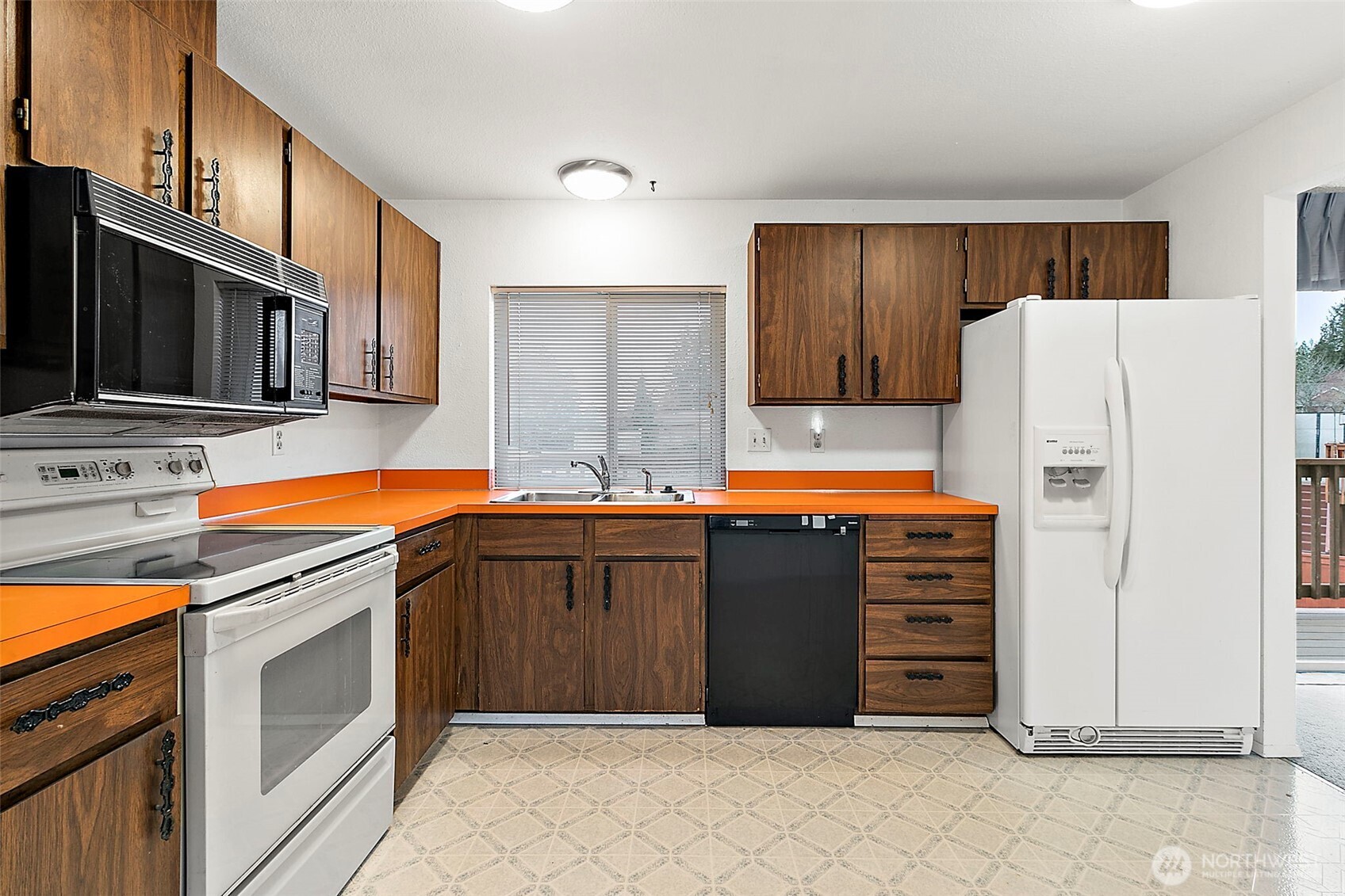 2115 Whitman Avenue Northeast Renton, WA 98059 - Photo 14 of 40 a kitchen with granite countertop a refrigerator and a sink