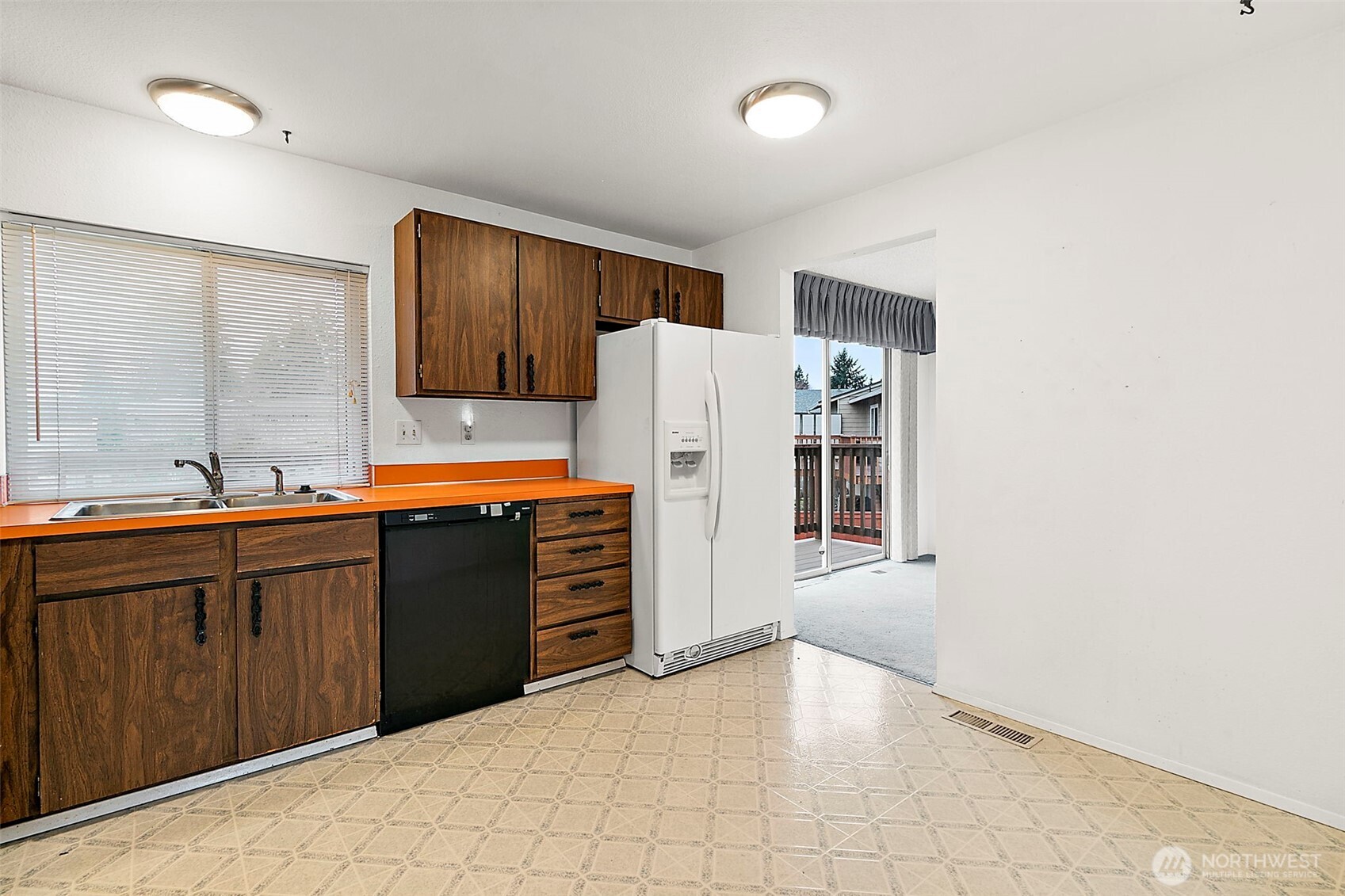 2115 Whitman Avenue Northeast Renton, WA 98059 - Photo 15 of 40 a kitchen with granite countertop a refrigerator and a sink