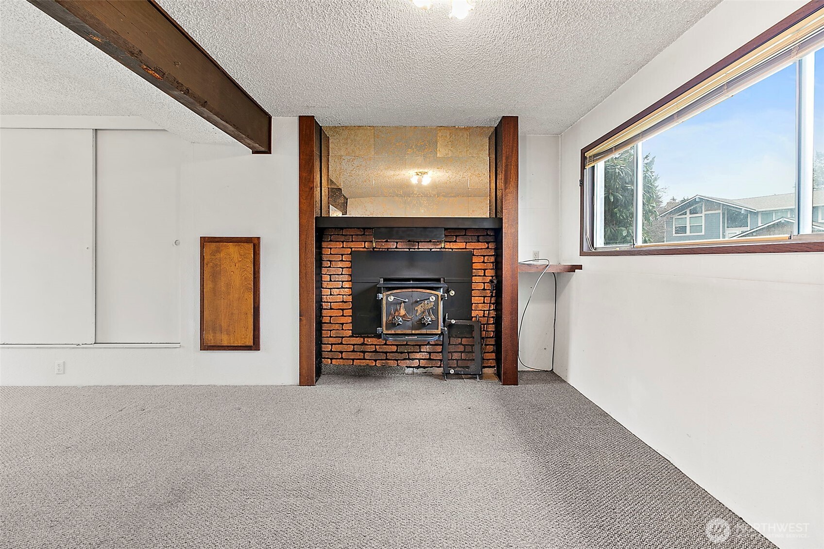 2115 Whitman Avenue Northeast Renton, WA 98059 - Photo 25 of 40 a view of an empty room with a fireplace and a window