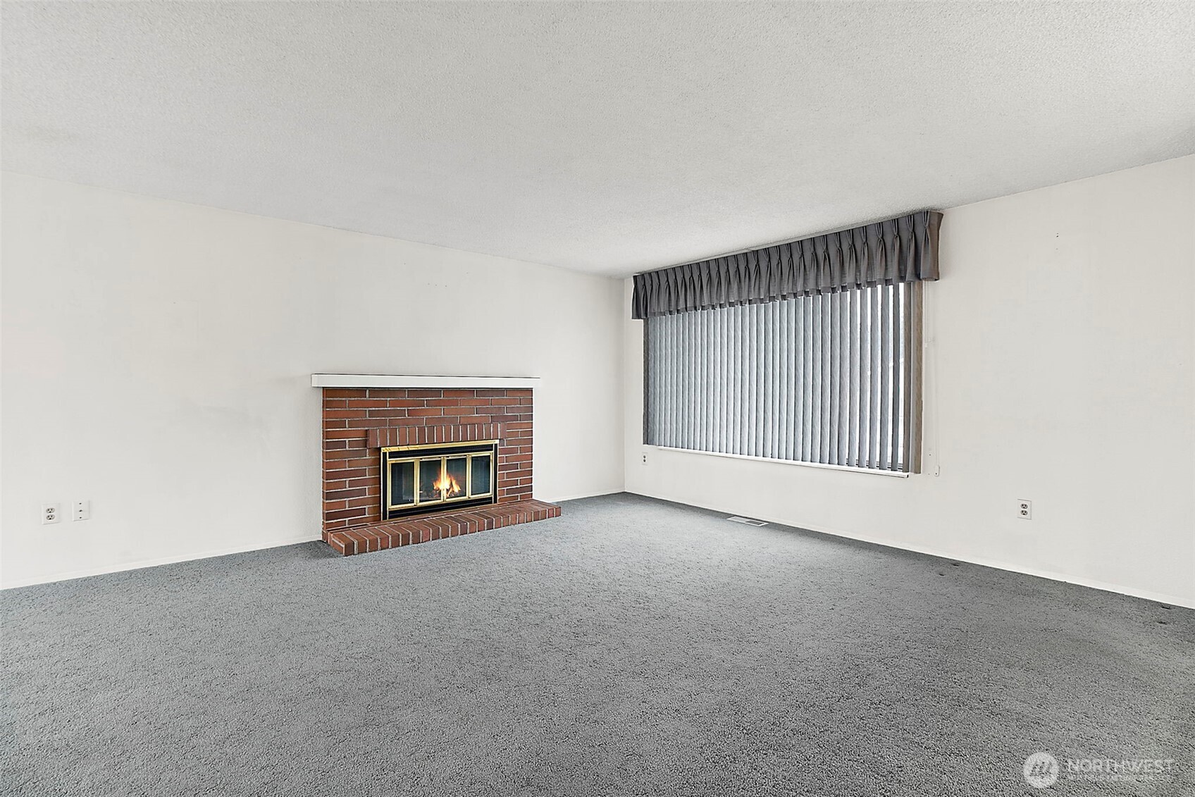 2115 Whitman Avenue Northeast Renton, WA 98059 - Photo 5 of 40 a view of an empty room with a fireplace and a window