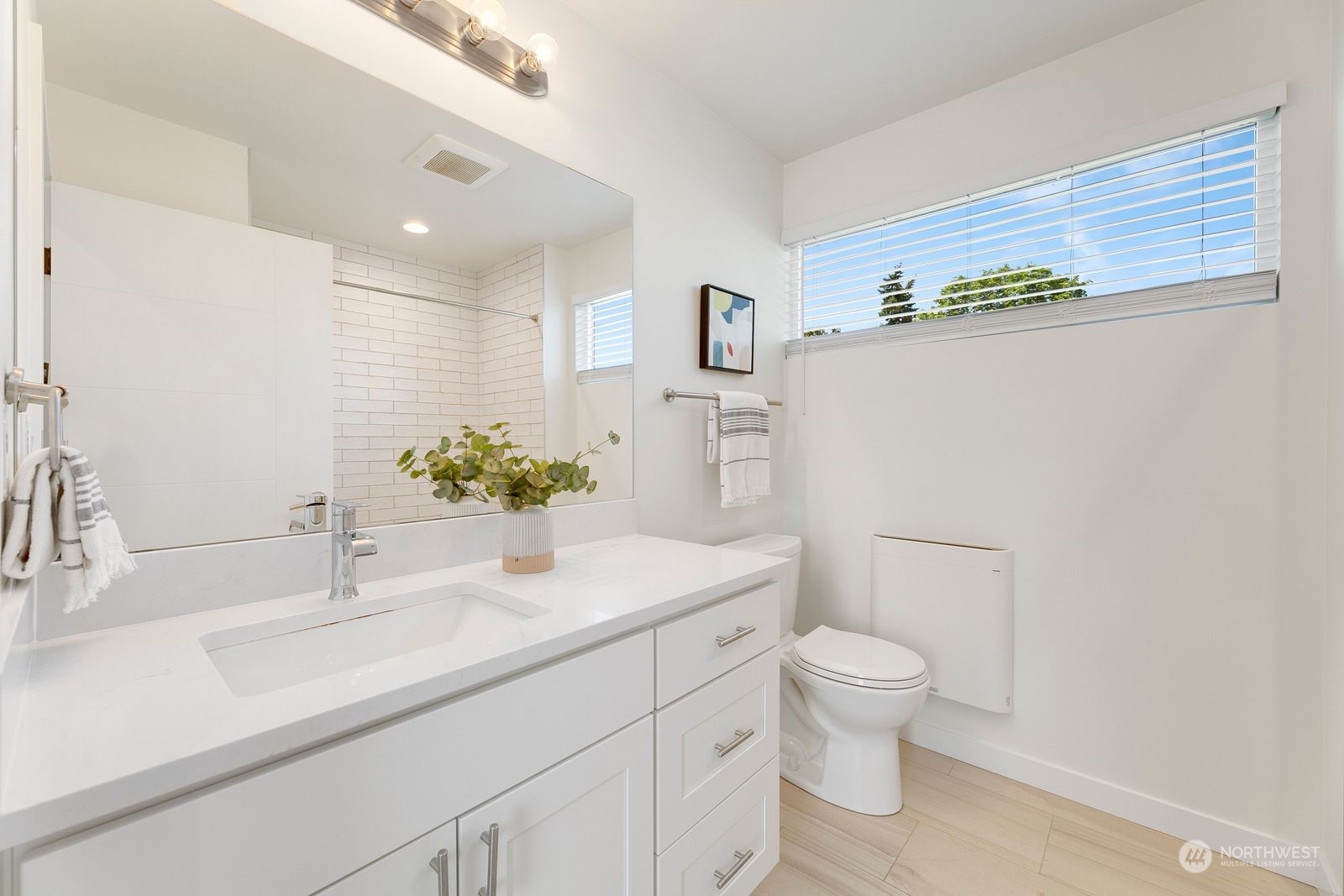 4246 South Graham Street Seattle, WA 98118 - Photo 13 of 21 a bathroom with a sink a toilet and a mirror