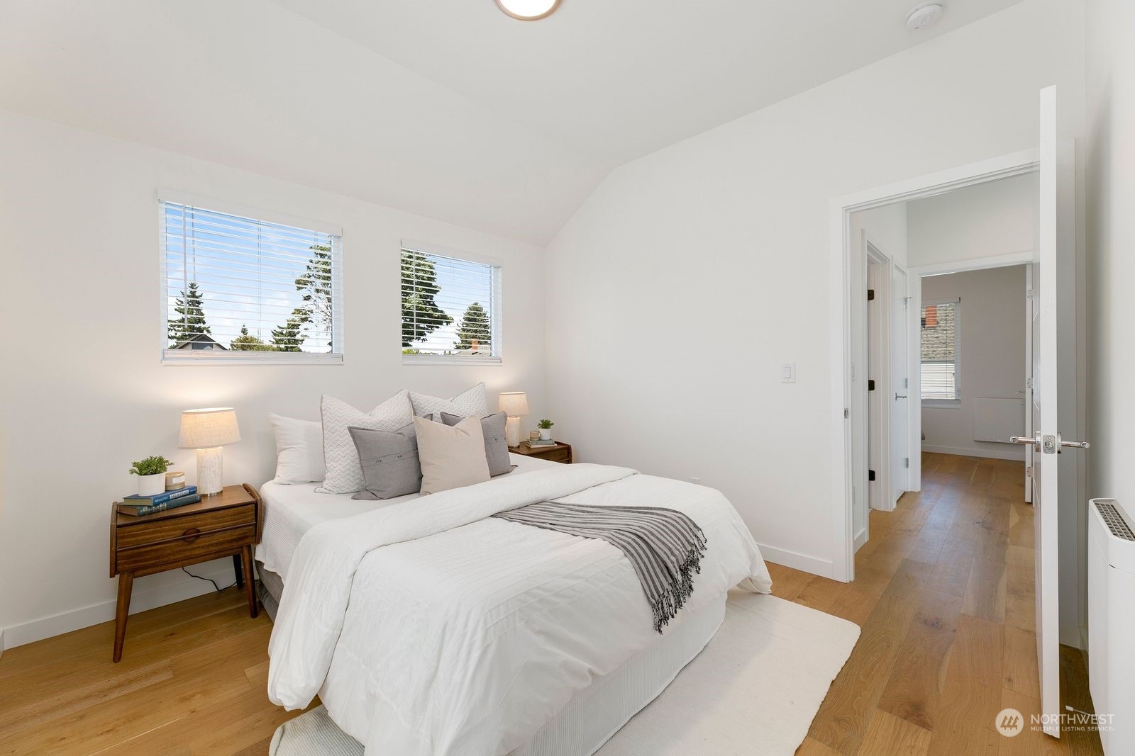 4246 South Graham Street Seattle, WA 98118 - Photo 19 of 21 a view of a bedroom with a bed and wooden floor