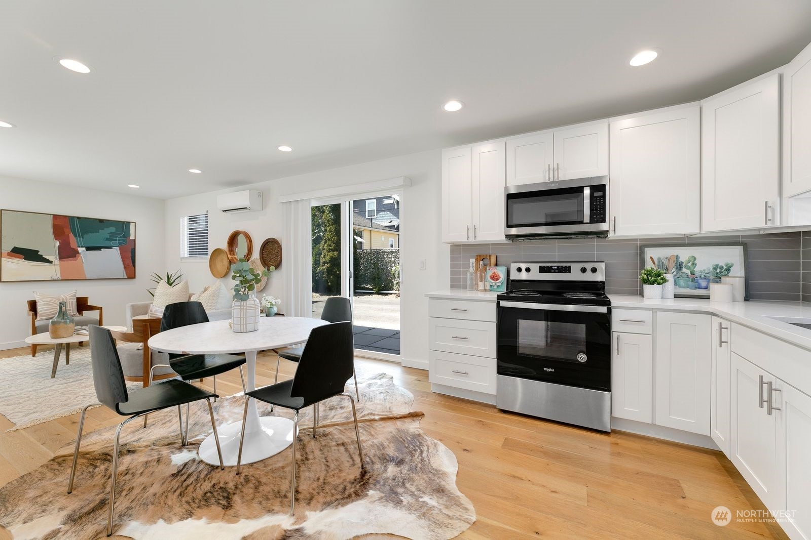 4246 South Graham Street Seattle, WA 98118 - Photo 2 of 21 a kitchen with stainless steel appliances a stove a sink a microwave a refrigerator and cabinets