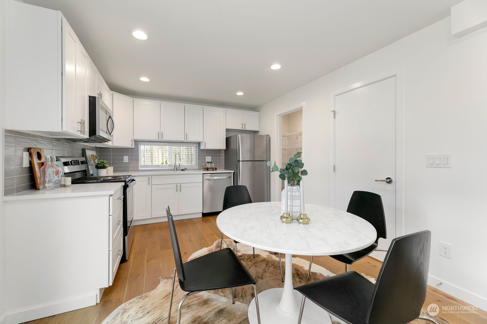 4246 South Graham Street Seattle, WA 98118 - Photo 3 of 21 a kitchen with a table and chairs in it