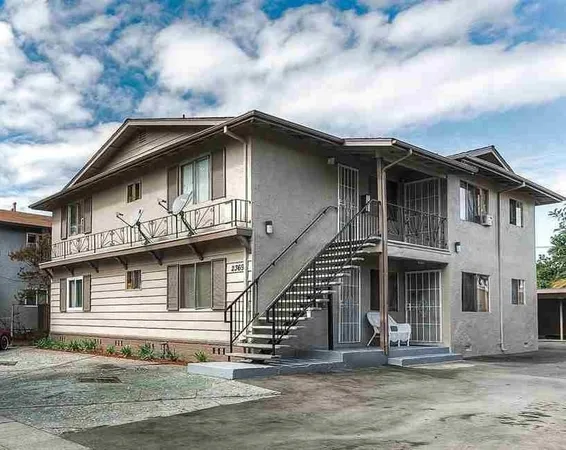 a white building with a clock on the roof