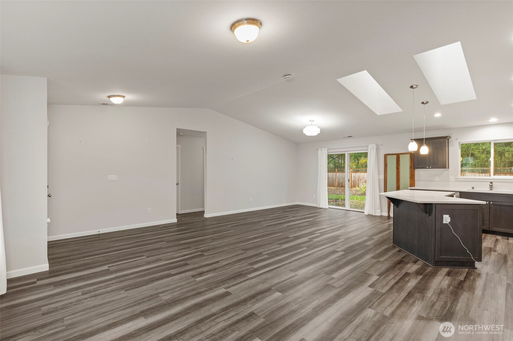 174 East Island View Avenue Port Townsend, WA 98368 - Photo 12 of 39 a view of an empty room with wooden floor and a window