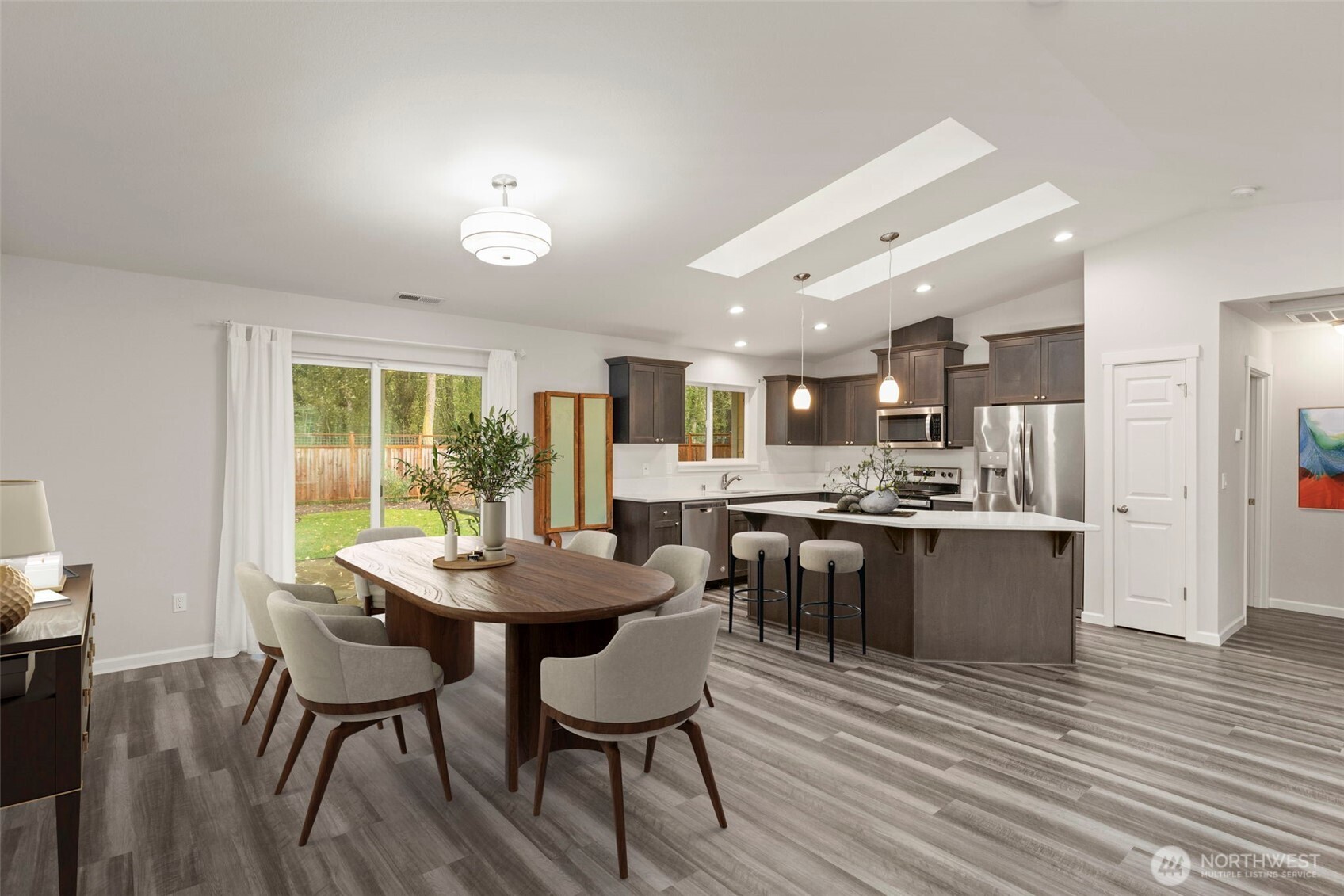 174 East Island View Avenue Port Townsend, WA 98368 - Photo 13 of 39 a dining room with stainless steel appliances kitchen island a table chairs and a kitchen view